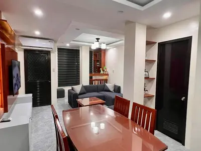a kitchen and living room with a table and a couch at Apartment Taguig Makati staycation with parking in Manila