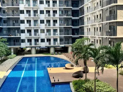 a swimming pool in front of a large building at Room 1691 Shore 3 Residences infront of SM MOA by Prime Stay in Manila