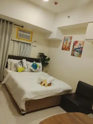 a bedroom with a bed with a cross on it at The Viceroy Tower Staycation at McKinley Hills Taguig in Manila