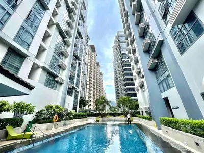 a swimming pool in the middle of two tall buildings at The Viceroy Tower Staycation at McKinley Hills Taguig in Manila