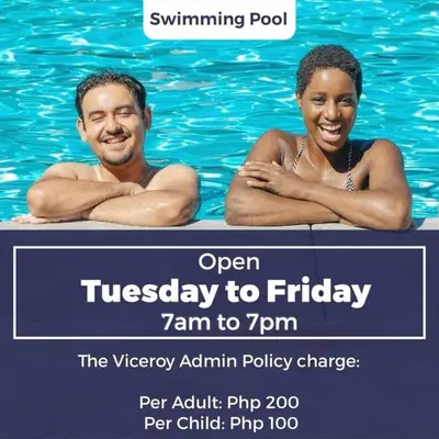 a man and a woman in the water at a swimming pool at The Viceroy Tower Staycation at McKinley Hills Taguig in Manila