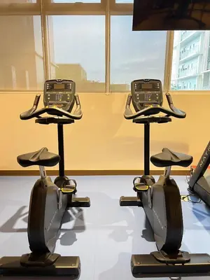 two exercise bikes on display in a gym at Luxe 1BR Condo - Near BGC & Venice Grand Canal in Manila