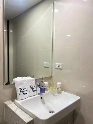 a bathroom with a white sink and a mirror at Luxe 1BR Condo - Near BGC & Venice Grand Canal in Manila