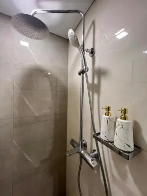a shower with two towels on a shelf in a bathroom at Luxe 1BR Condo - Near BGC & Venice Grand Canal in Manila