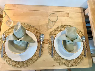 a table with two plates and a hat on it at Captivating Crib in the Metro in Manila