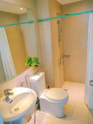 a bathroom with a white toilet and a sink at Azure Place Maui 8th floor in Manila