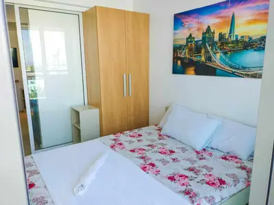 a bedroom with a bed with pink flowers on it at Azure Place Maui 8th floor in Manila