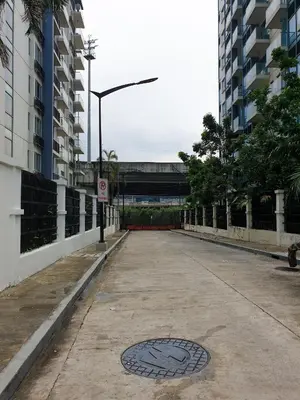 a street with a manhole in the middle of a road at Layover Stay Condotels at Two Palm Tree Villas in Manila