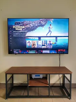 a flat screen tv hanging on a wall at Layover Stay Condotels at Two Palm Tree Villas in Manila