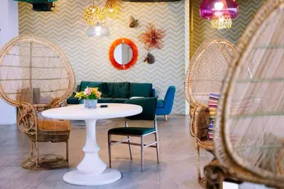 a room with a table and chairs and a couch at Novotel Rockwell View Hotel Residences in Manila