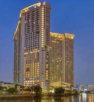 a large building with a sign on the side of it at Novotel Rockwell View Hotel Residences in Manila