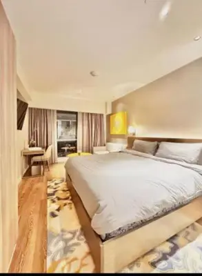 a bedroom with a large bed in a room at Novotel Rockwell View Hotel Residences in Manila