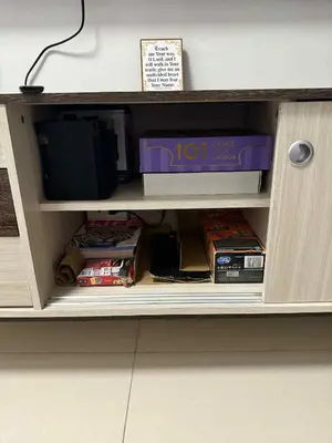 a cabinet with a tv and boxes in it at The Calm Corner - S Residences Tower 2 in Manila