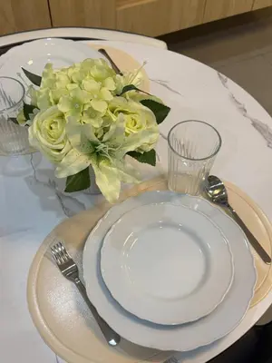 a table with a white plate and a vase of flowers at Sunny side Cityscape C2 RM 1716 Shore Residences by Prime Stay MOA in Manila
