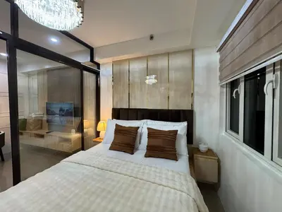 a bedroom with a large bed and a large window at Sunny side Cityscape C2 RM 1716 Shore Residences by Prime Stay MOA in Manila