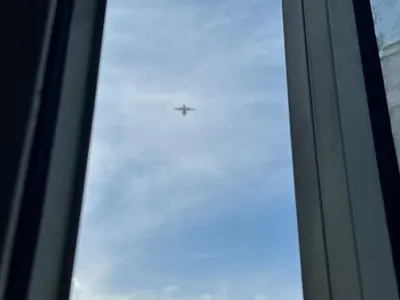 a plane flying in the sky through a window at Sunny side Cityscape C2 RM 1716 Shore Residences by Prime Stay MOA in Manila