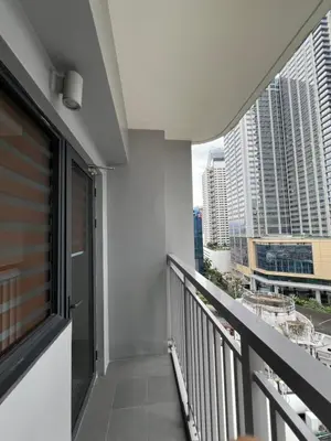 a balcony with a view of a city at Calle Homes - 1BR unit with balcony, LUSH RESIDENCES in Manila
