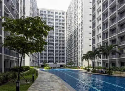 a swimming pool in the middle of two tall buildings at Twin Unit at Shore 2 Residences in Manila