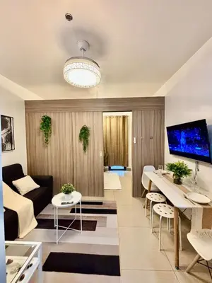 a living room with a couch and a table at Twin Unit at Shore 2 Residences in Manila