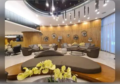 a living room with a large bed and couches at Twin Unit at Shore 2 Residences in Manila