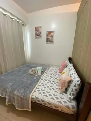 a small bed in a room with at Haven's Suites a place like home in Manila