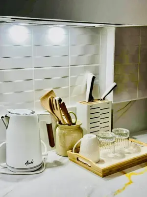 a kitchen counter top with a coffee maker and utensils at Sea Residences in Manila
