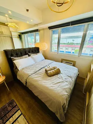 a bedroom with a bed with a teddy bear on it at Sea Residences in Manila