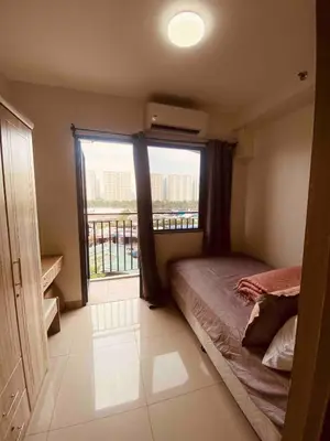 a bedroom with a bed and a large window at Mall of Asia Netflix Disney WIFI IKEA ARENA NAIA SHORE2 418 in Manila