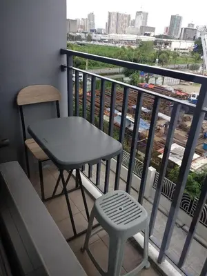 a table and a chair on a balcony with a view at Mall of Asia Netflix Disney WIFI IKEA ARENA NAIA SHORE2 418 in Manila