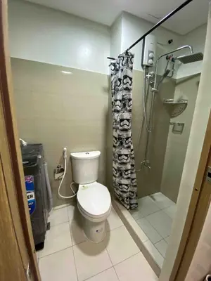 a bathroom with a toilet and a shower at Mall of Asia Netflix Disney WIFI IKEA ARENA NAIA SHORE2 418 in Manila