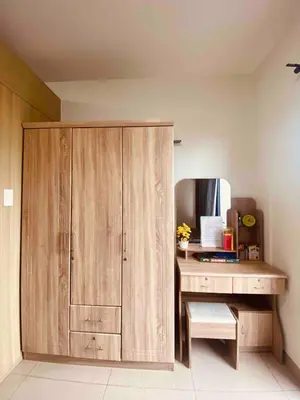 a wooden cabinet in a room with a desk at Mall of Asia Netflix Disney WIFI IKEA ARENA NAIA SHORE2 418 in Manila