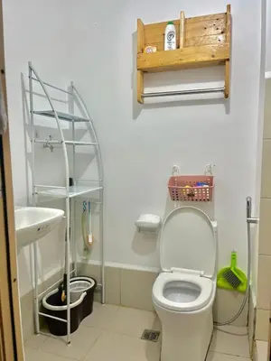 a bathroom with a toilet and a sink at Taguig Condo Unit - Grace Residences by Jenn in Manila
