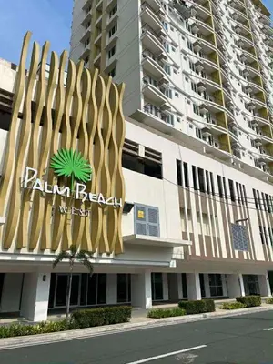 a building with a palm retrieval sign on it at Jolgeous Staycations and Rentals in Manila