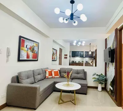a living room with a couch and a table at Jolgeous Staycations and Rentals in Manila