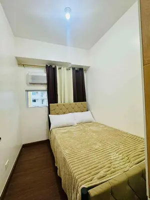 a small bedroom with a bed in a room at Jolgeous Staycations and Rentals in Manila