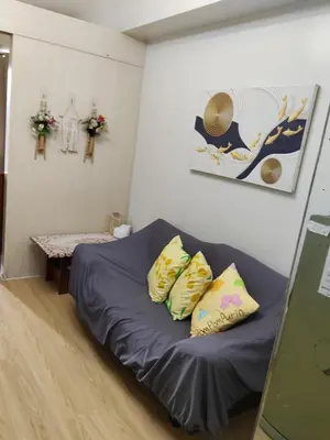 a small room with a bed and two pillows at Lhan residence in Manila