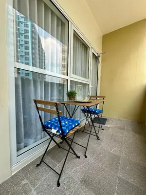 a table and chairs in a room with a window at The Bloom by Y&Y Condo at Bayshore Res Resort in Manila