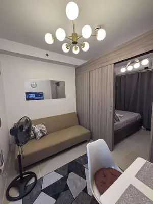 a living room with a couch and a bed at Shore 2 Tower 1 MOA MallofAsia ARENA IKEA NAIA 685 in Manila