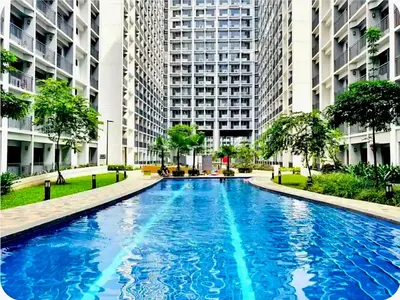 a large blue pool in a city with tall buildings at Shore 2 Tower 1 MOA MallofAsia ARENA IKEA NAIA 685 in Manila