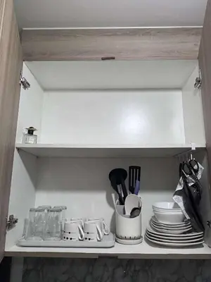 a shelf with plates and utensils in a kitchen at Shore 2 Tower 1 MOA MallofAsia ARENA IKEA NAIA 685 in Manila