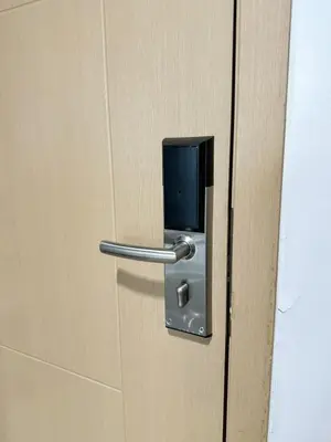 a door with a metal handle on a wooden door at New Cozy 2-bedroom deluxe condo for 5 pax in MOA in Manila