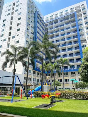 a playground in front of a large building at New Cozy 2-bedroom deluxe condo for 5 pax in MOA in Manila