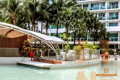 a pool at a resort with palm trees and a building at Havenscape Staycation in Manila