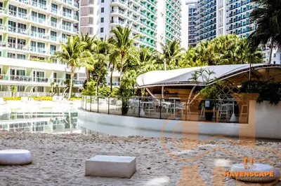 a building with chairs and palm trees and buildings at Havenscape Staycation in Manila