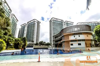 a swimming pool in front of a building with tall buildings at Havenscape Staycation in Manila