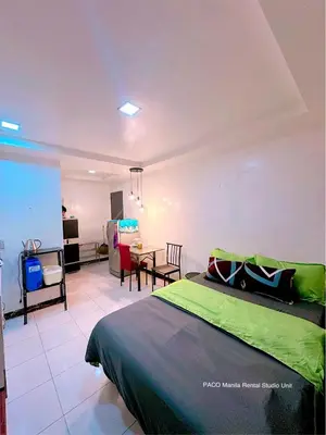 a bedroom with a bed and a dining room at Paco Manila Rental Studio Unit in Manila