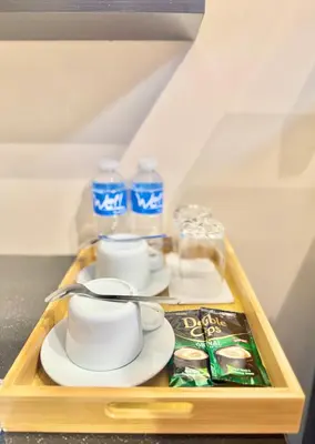 a tray with cups and plates and water bottles at Aura Zen Suites condotel in Manila