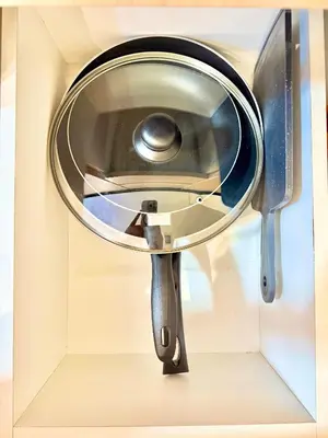 a mirror hanging on a wall with a knife at Aura Zen Suites condotel in Manila