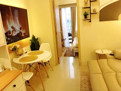 a living room with a table and a couch at Lovers' Cozy 1BR Condo Near Mall and Airport with Free Netflix Premium and 100 MBPS WiFi in Manila