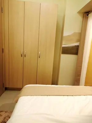 a bedroom with two bunk beds and two closets at Lovers' Cozy 1BR Condo Near Mall and Airport with Free Netflix Premium and 100 MBPS WiFi in Manila